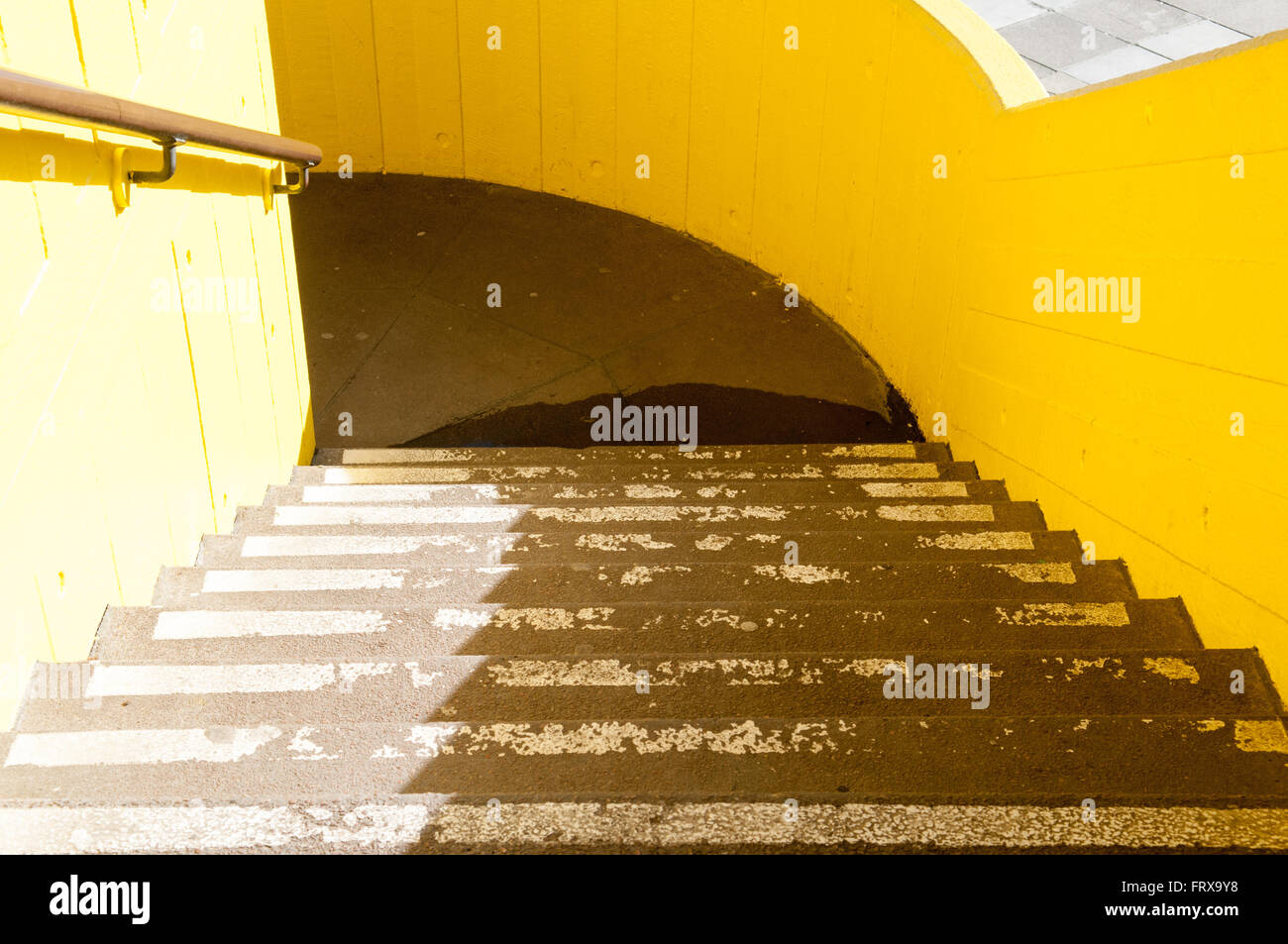 Set of car park stairs with a shadow being cast across them Stock Photo