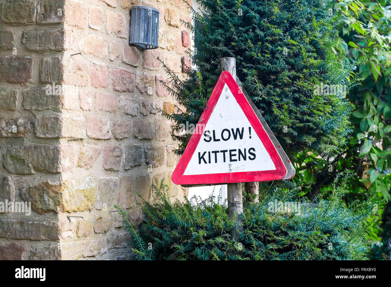 Cotswolds, United Kingdom - September 07, 2013: Cute and funny handmade 'Slow Kittens' road sign Stock Photo