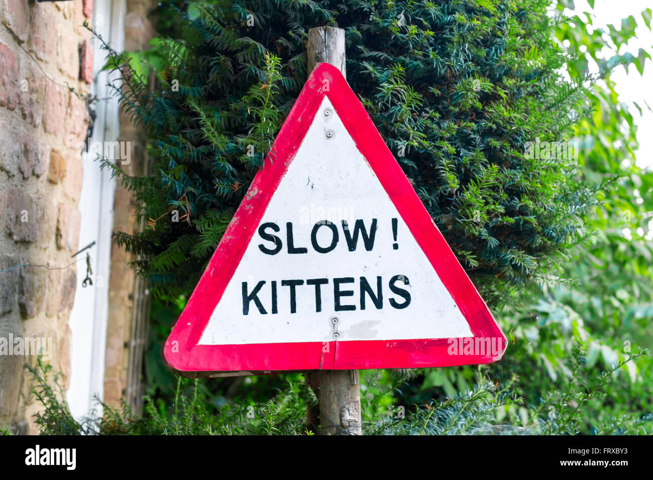 Cotswolds, United Kingdom - September 07, 2013: Cute and funny handmade 'Slow Kittens' road sign Stock Photo