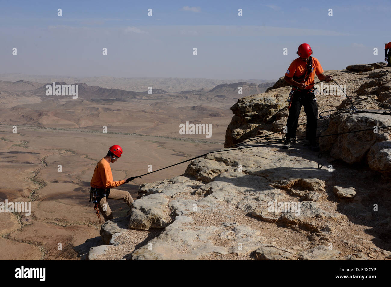 Climbing at the crater of Ramon near Mizpe Ramon, Desert of Negev, South-Israel, Israel Stock Photo