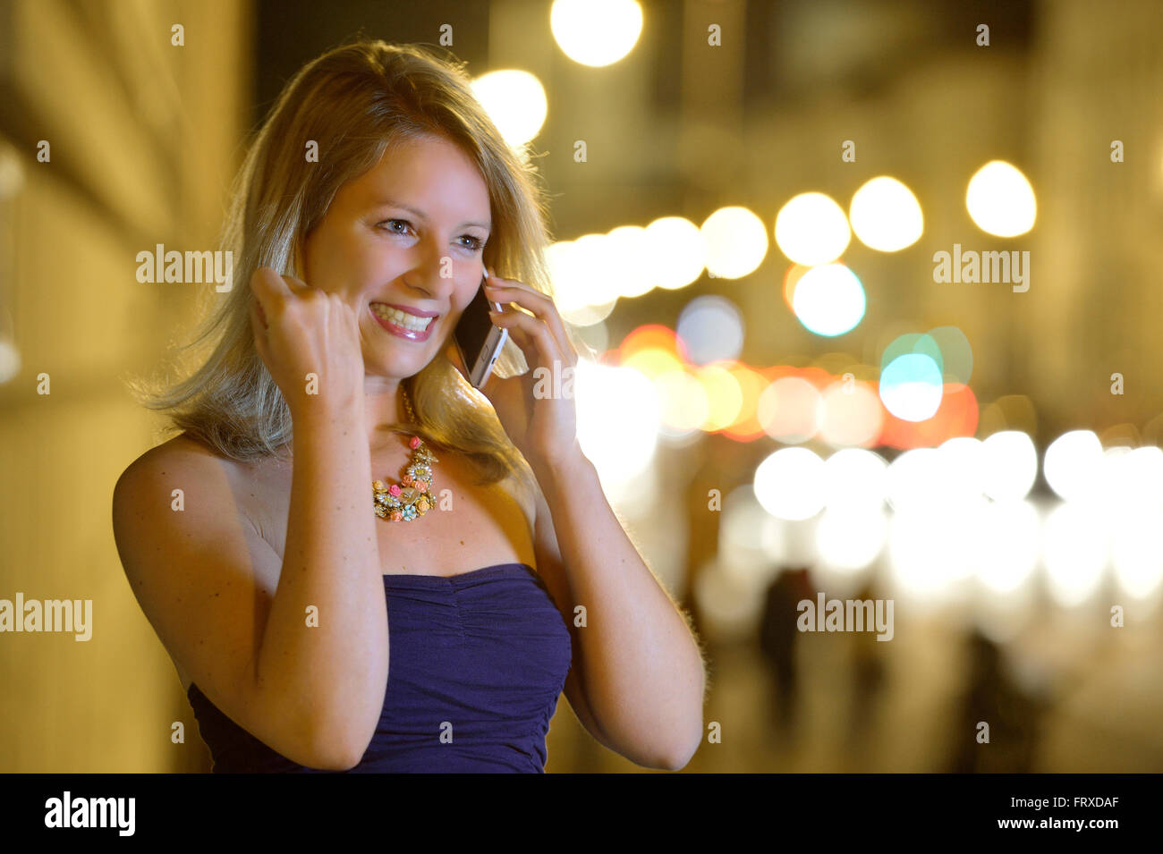 Young woman phoning with a mobile phone, Munich, Upper Bavaria, Bavaria, Germany Stock Photo