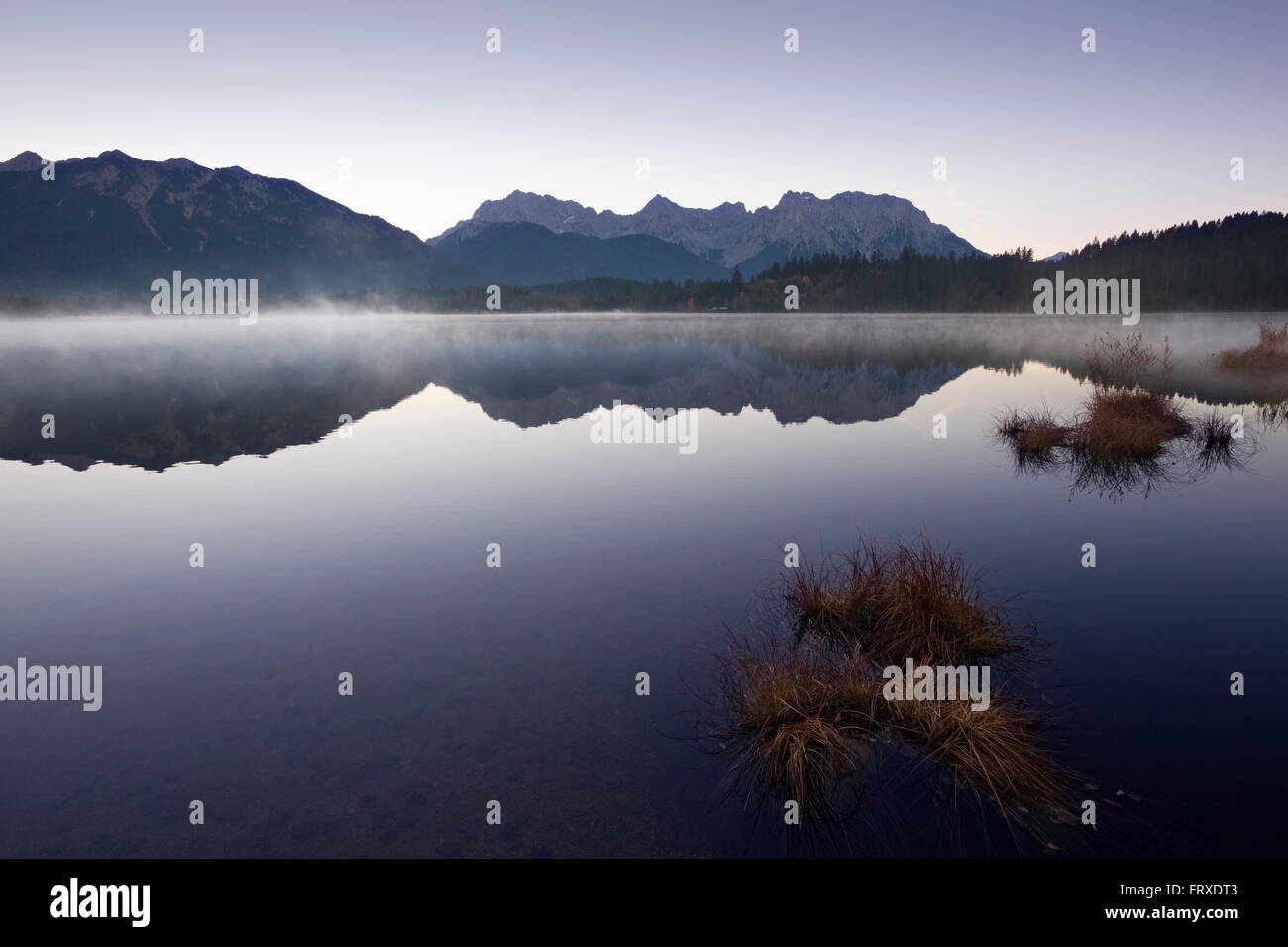 Morning mist, view over lake Barmsee to the Soiern mountains and ...