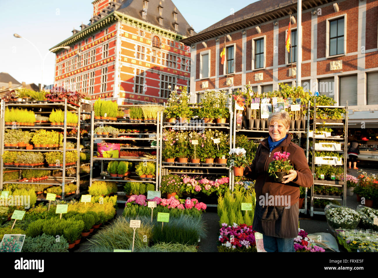 Female flower seller at La Batte market, Curtius Museum im background