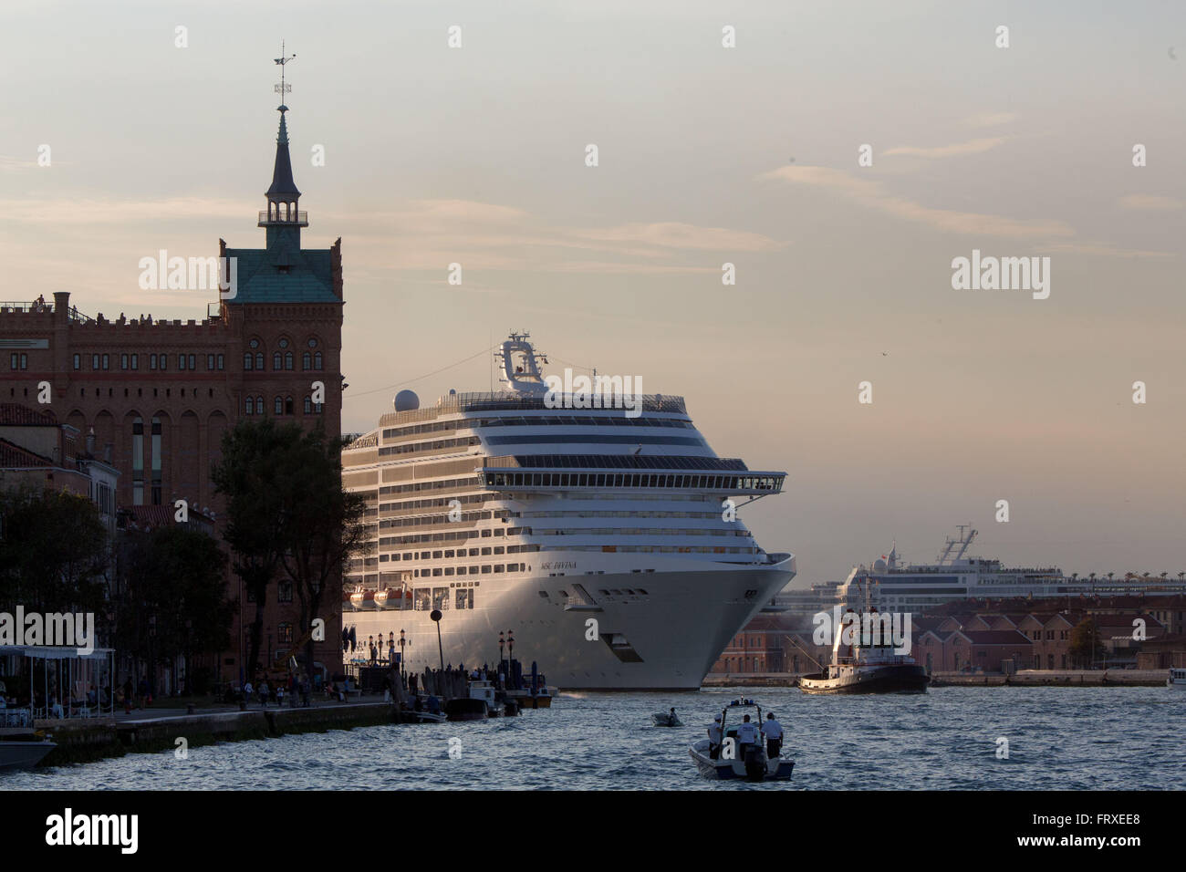 Cruise ship protest, Cruise ship being towed in Giudecca Canal near Molino Stucky Hotel, Venice, Veneto, Italy Stock Photo