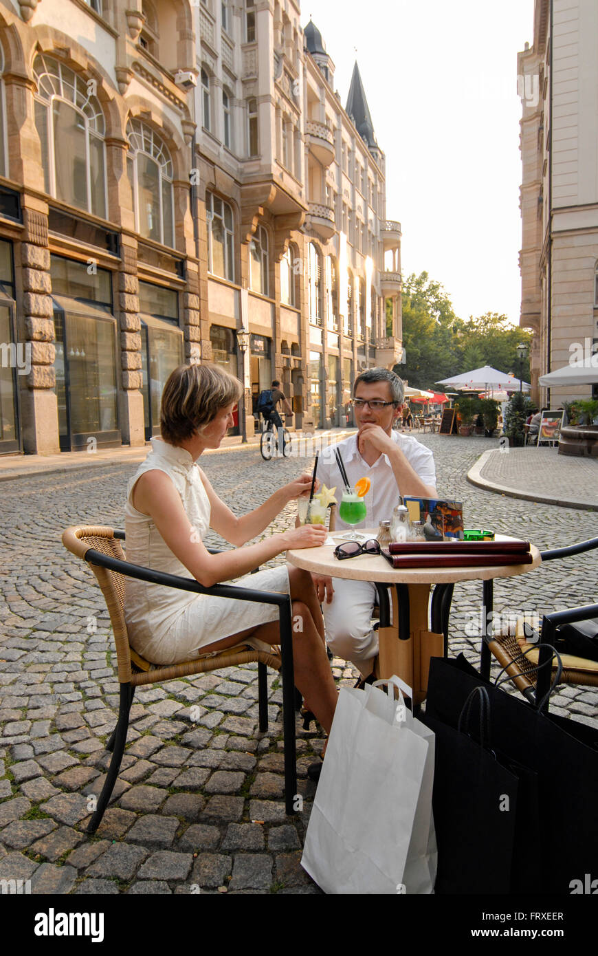 Couple in a pavement cafe, Barfussgaesschen, Leipzig, Saxony, Germany Stock Photo