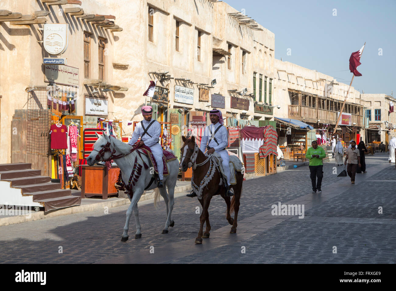 Police officers on horseback patrol at Souq Waqif, Doha, Qatar Stock Photo