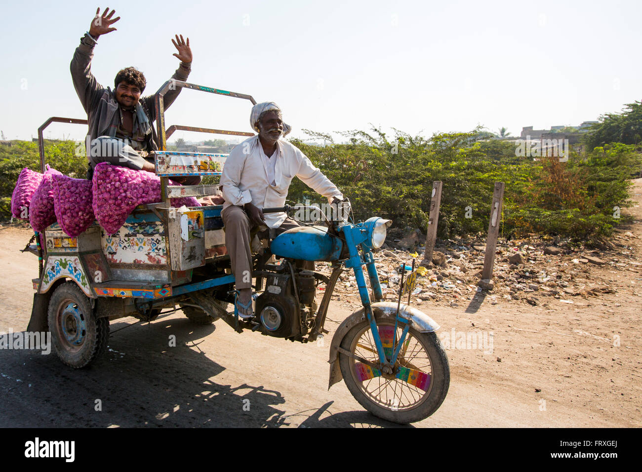 Onion seller on a motorised rickshaw on his way to the market, Porbandar, Gujarat, India Stock Photo