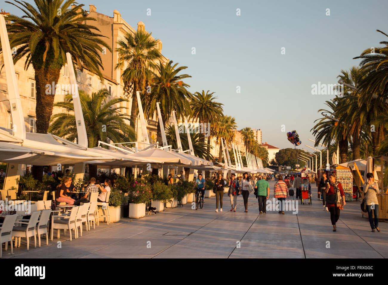 People sitting in outdoor cafes along The Riva seafront promenade, Split, Split-Dalmatia, Croatia Stock Photo