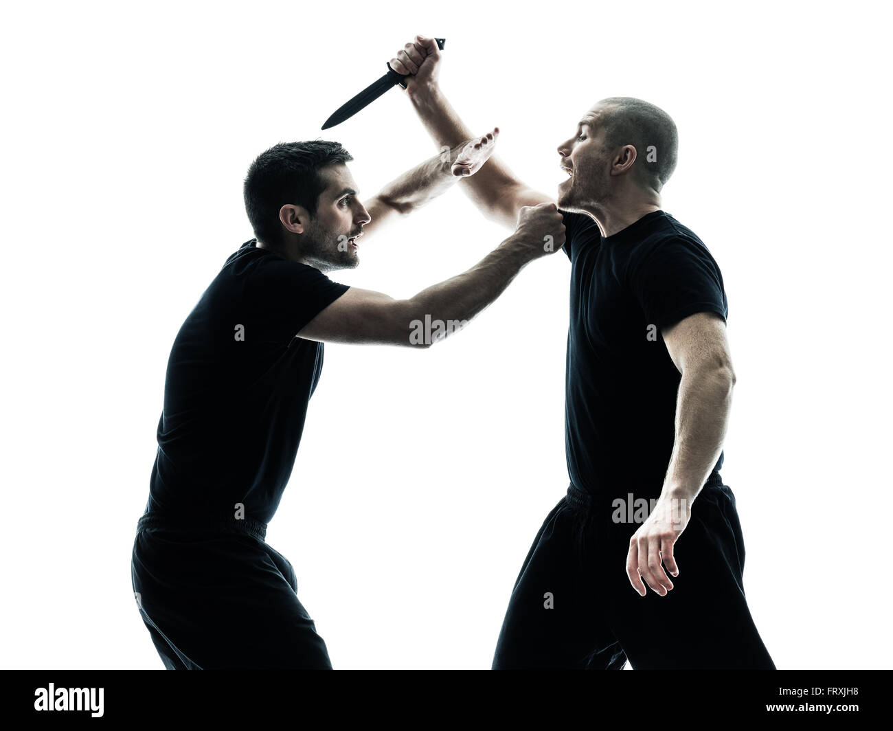 two caucasian men krav maga fighters fighting isolated silhouette on ...