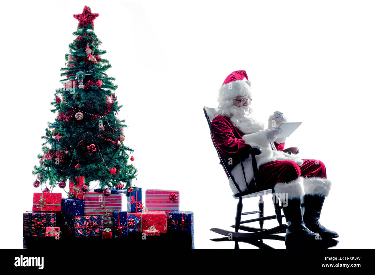 one santa claus man using digital Tablets silhouette isolated on white ...