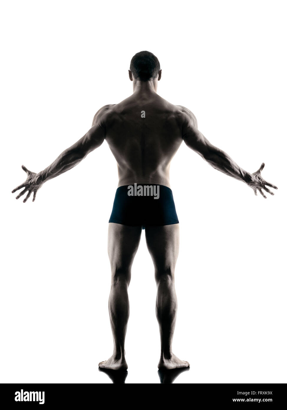 one caucasian man exercising fitness body building exercises in studio in silhouette isolated Stock Photo