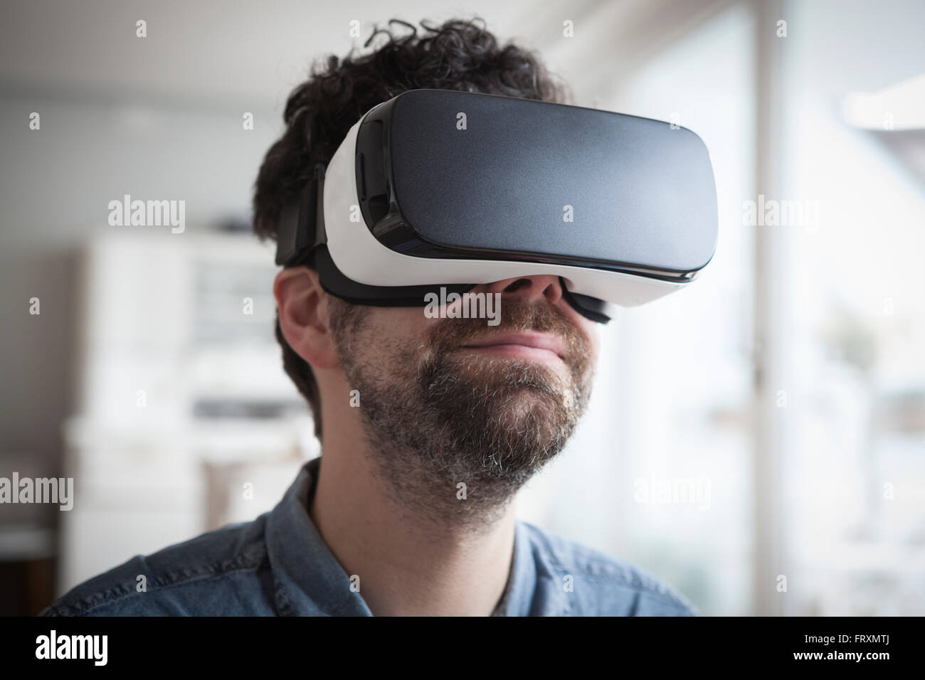 Smiling man wearing Virtual Reality Glasses Stock Photo - Alamy