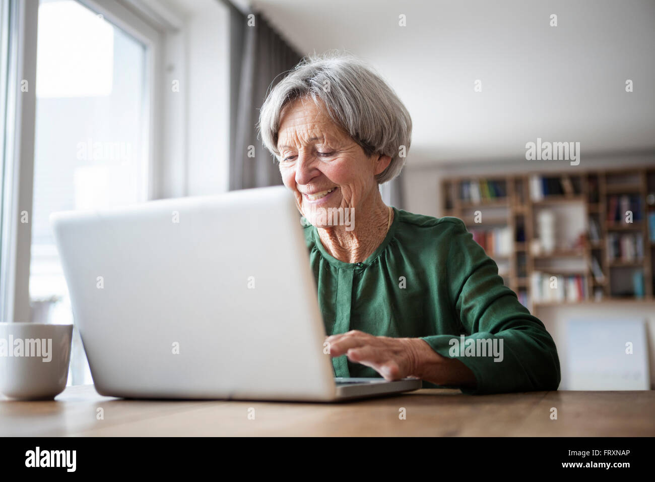 Portrait of senior woman using laptop at home Stock Photo