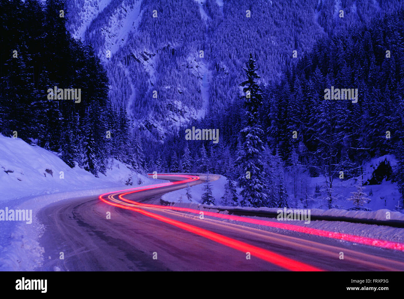Streaking Car Tail Lights on a Road in Winter, Banff National Park, Alberta, Canada Stock Photo