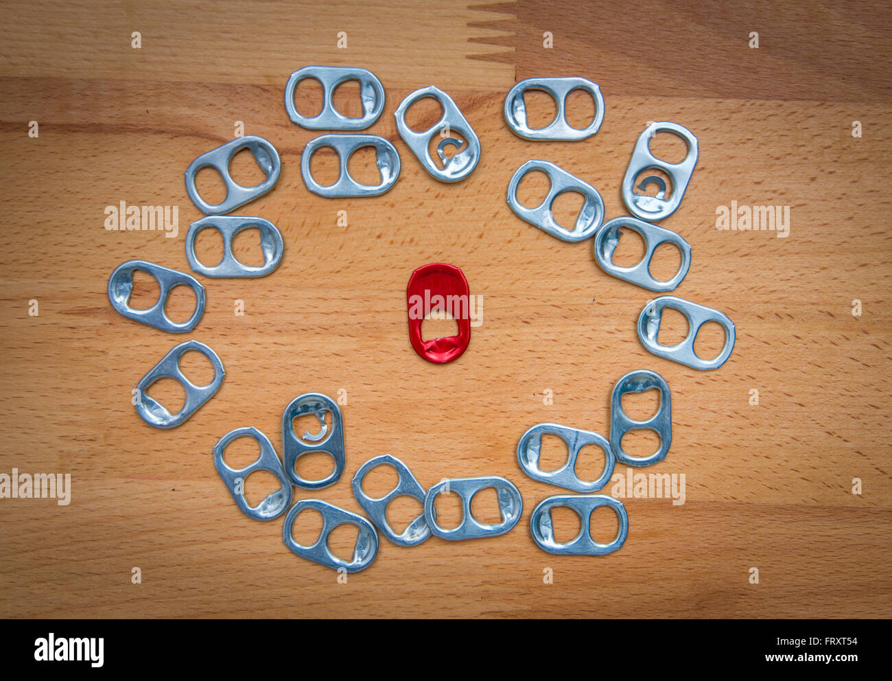 Red metal ring pull standing out from the crowd, leadership, difference concept Stock Photo
