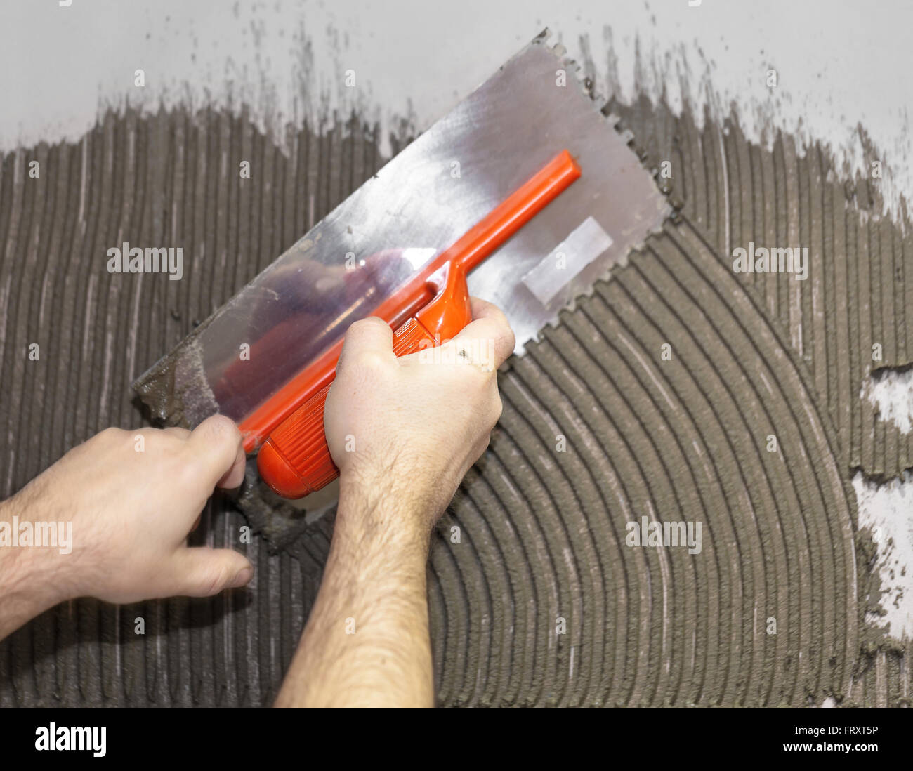 Worker tiler put cement on the wall Stock Photo Alamy