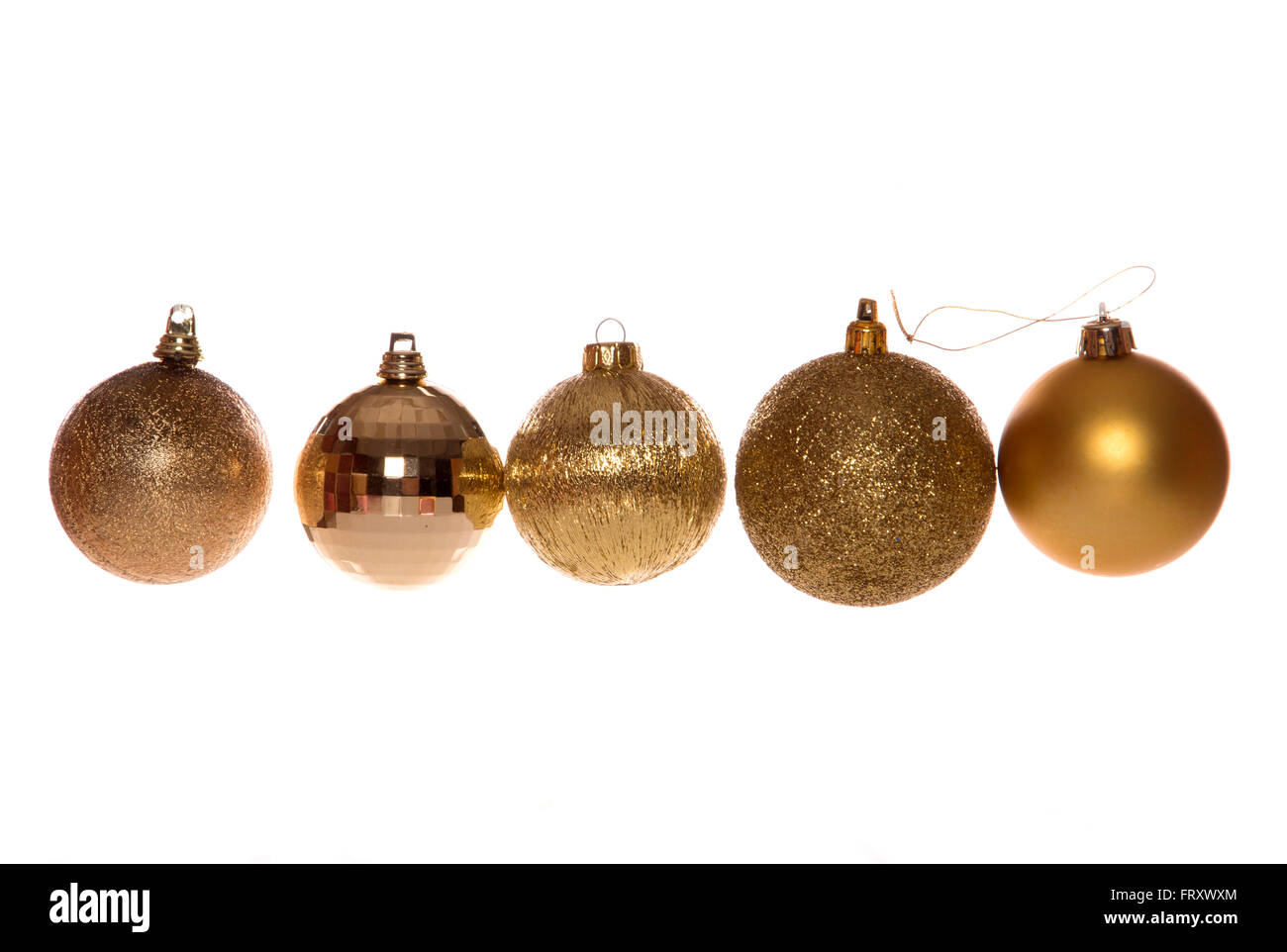 five gold christmas tree baubles cutout Stock Photo