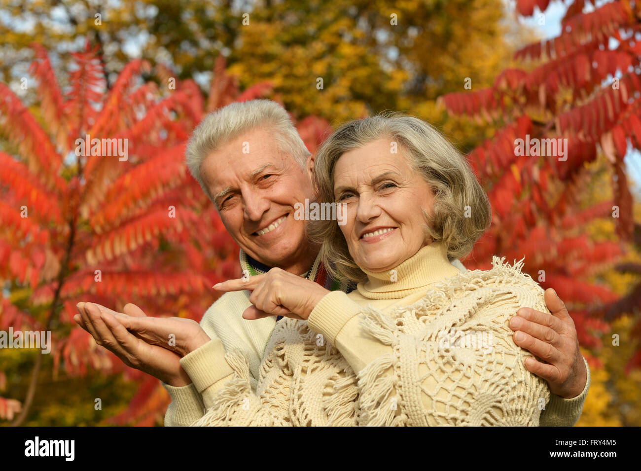 Old couple posing at autumn park Stock Photo - Alamy