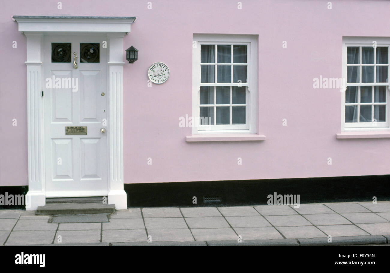 Exterior of pale pink early Victorian house with a white front door Stock Photo