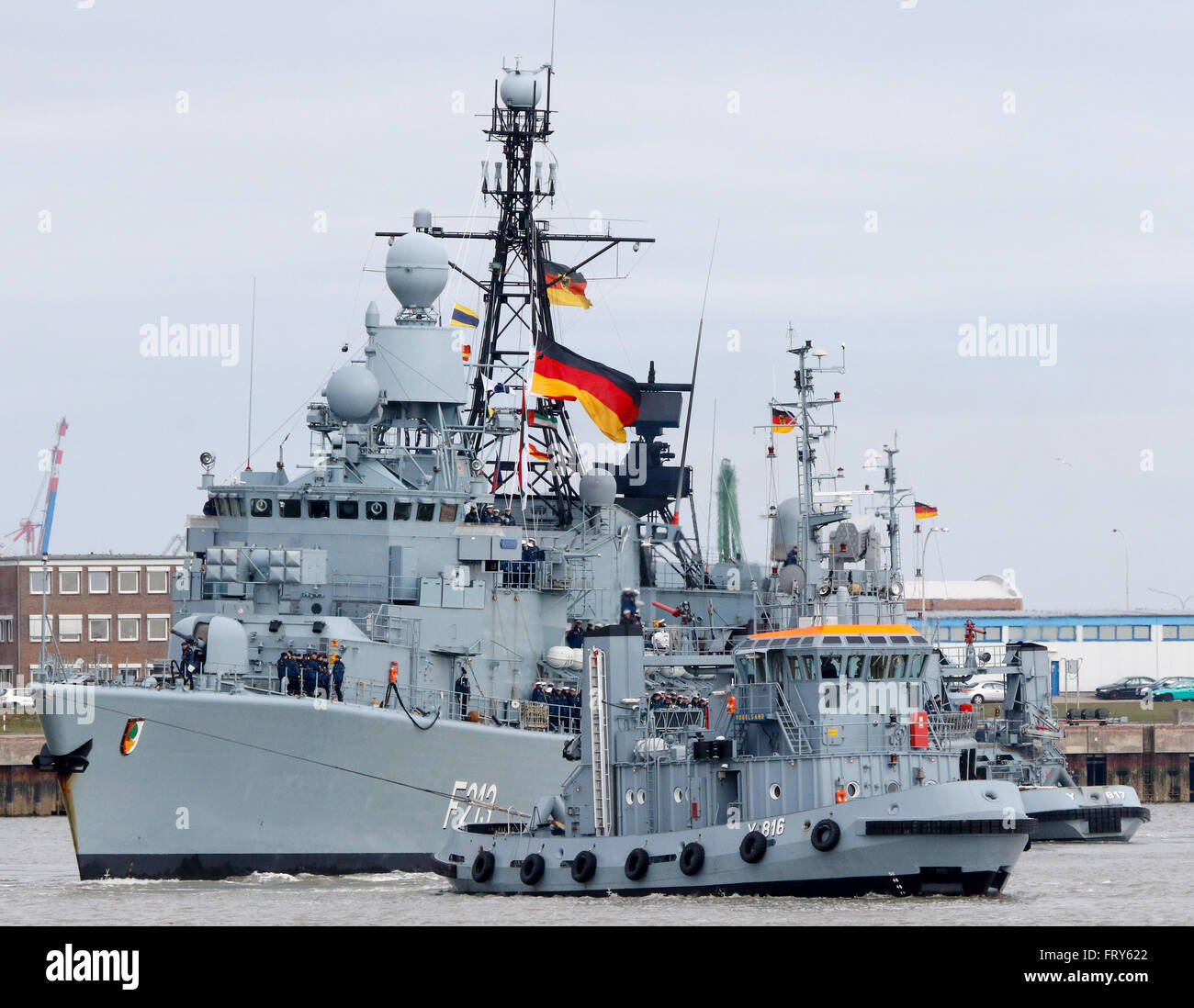 Wilhelmshaven, northern Germany, March 24, 2016: A tug boat tows the ...