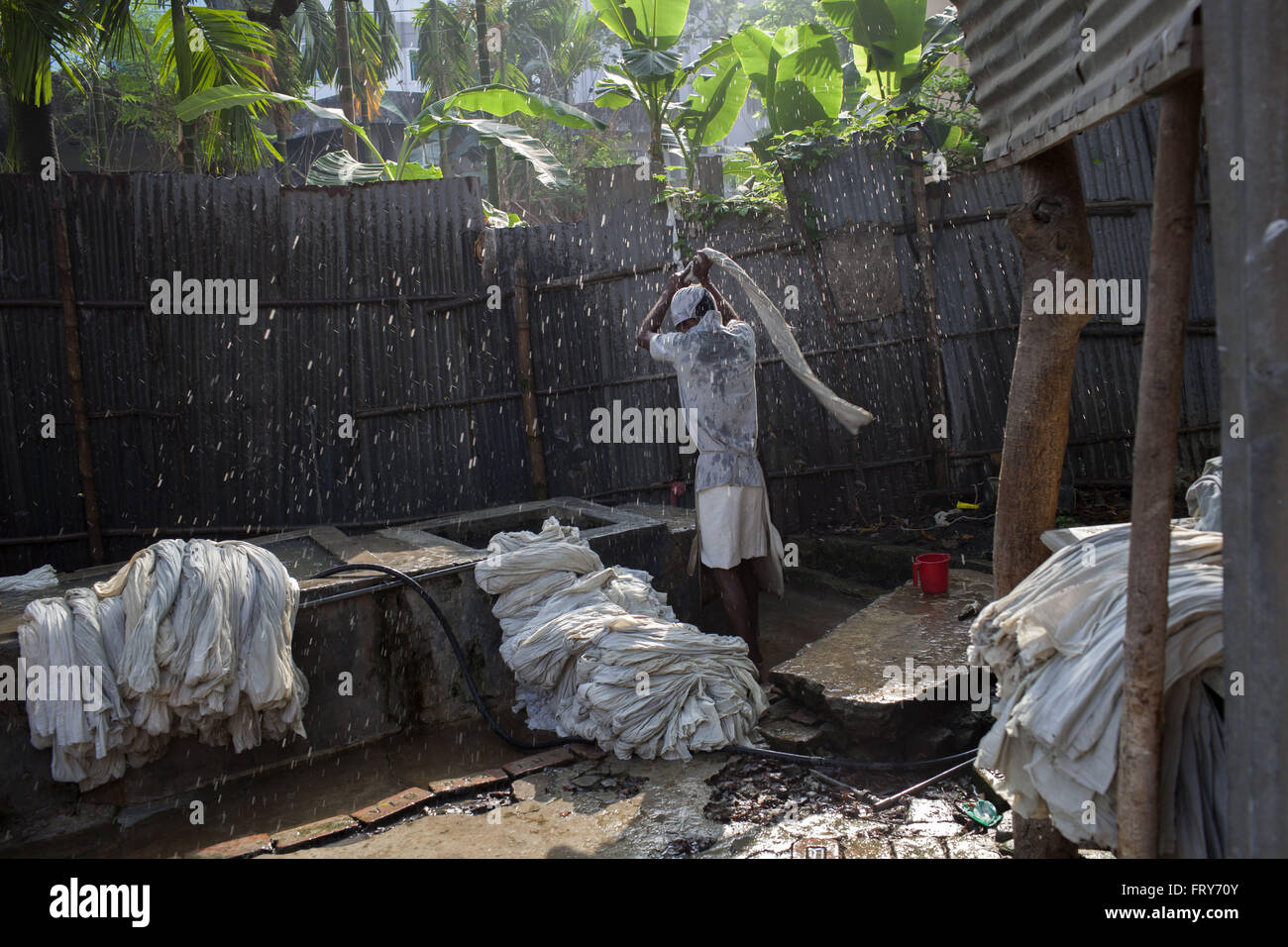 Dhaka, Dhaka, Bangladesh. 24th Mar, 2016. A man washes TB patients' bedcovers near the National Institute of Diseases of Chest and Hospital on World Tuberculosis Day in Dhaka, Bangladesh, Thursday, March 24, 2016. Tuberculosis (TB) is a worldwide public health problem. The incident of TB is much higher in developing countries such as Bangladesh. The country ranks sixth among 22 highest burden TB countries in the world. The World Health Organization estimates that approximately 570000 people are currently suffering from TB disease in Bangladesh. Every year more than 300,000 people develop T Stock Photo