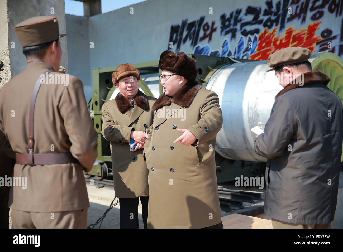 Pyongyang, DPRK. 24th March, 2016. Photo provided by Korean Central News Agency (KCNA) on March 24, 2016 shows the top leader of the Democratic People's Republic of Korea (DPRK) Kim Jong Un guiding a ground test for heavy-lift, solid-fuel rocket engine and its separation. The top leader of the Democratic People's Republic of Korea (DPRK) Kim Jong Un has guided a ground test for heavy-lift, solid-fuel rocket engine and its separation, the country's official news agency KCNA reported Thursday. Credit:  Xinhua/Alamy Live News Stock Photo