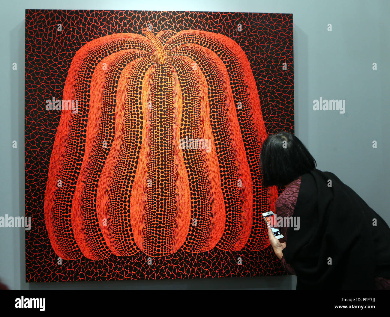 Hong Kong, China. 24th Mar, 2016. A visitor watches a creation by Yayoi Kusama at the Art Basel in Hong Kong, south China, March 24, 2016. A total of 239 galleries from 35 countries and regions attended the 3-day Art Basel in Hong Kong this year. Credit:  Li Peng/Xinhua/Alamy Live News Stock Photo