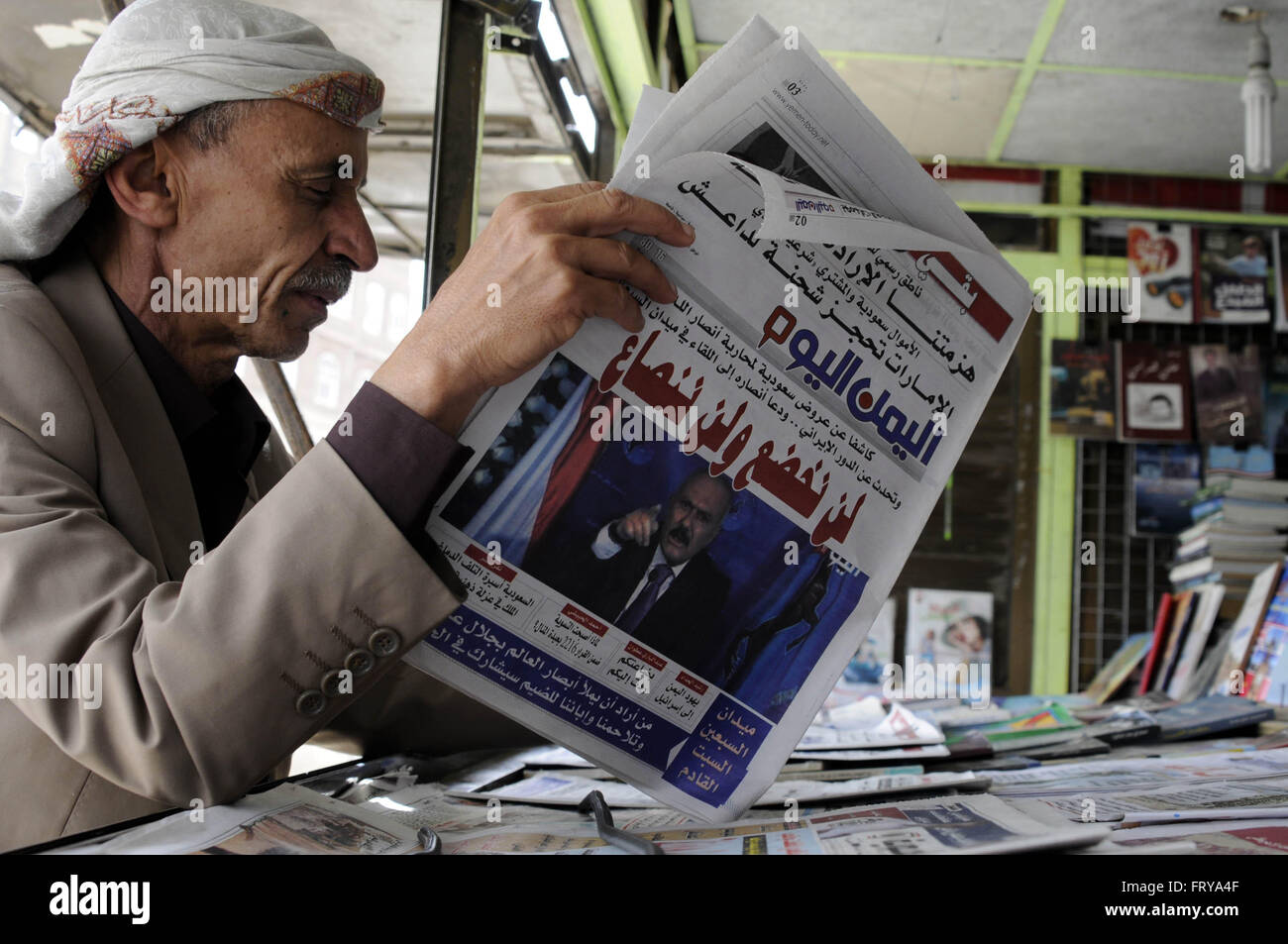 Sanaa, Yemen. 24th Mar, 2016. A Yemeni man reads a daily newspaper