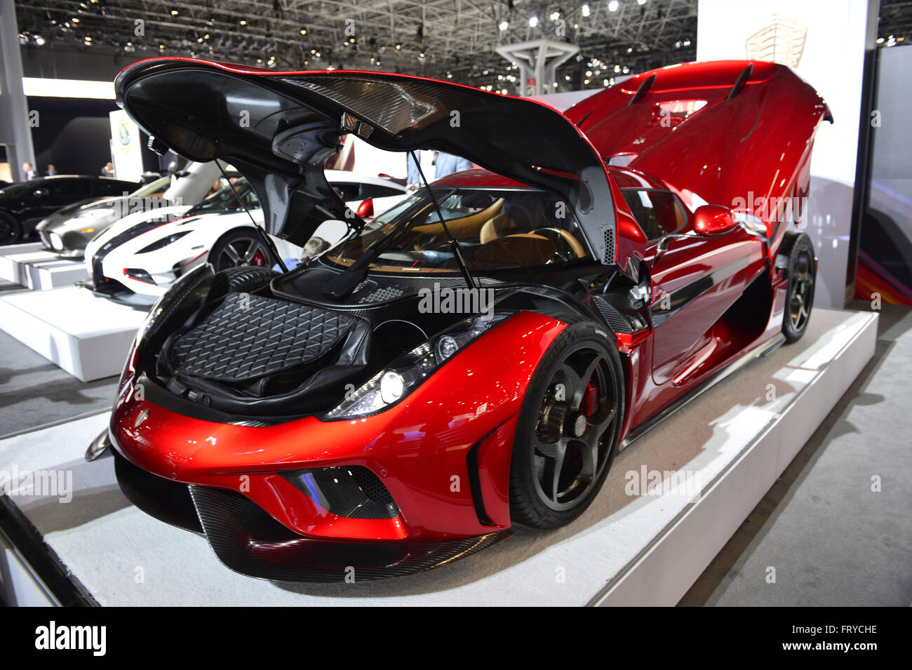 Manhattan, New York, USA. 23rd Mar, 2016. The Koenigsegg Regera, with red exterior and black interior and costs over 2 million dollars on road, is on display with open hood and trunk at the New York International Auto Show 2016, at the Jacob Javits Center. Thirty of these cars have been sold, and Regera means ''to reign'' in Swedish. This was Press Preview Day one of NYIAS, and the Trade Show will be open to the public for ten days, March 25th through April 3rd. © Ann Parry/ZUMA Wire/Alamy Live News Stock Photo