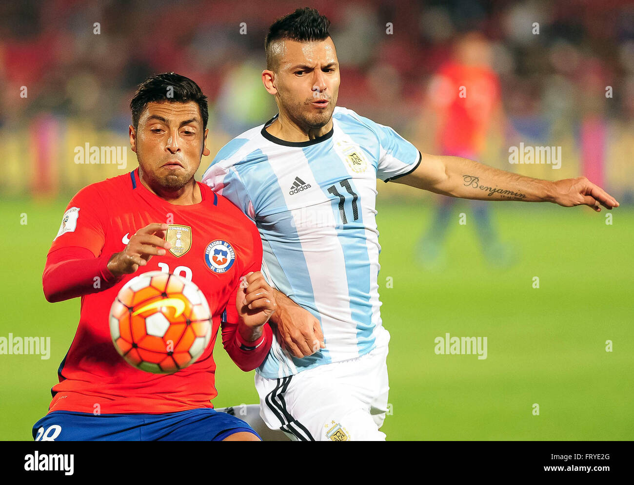Santiago, Chile. 24th Mar, 2016. Chile's Gonazalo Jara (L) vies with Argentina's Sergio Aguero during the qualifying match for the Russia 2018 FIFA World Cup at the National Stadium in Santiago, capital of Chile, on March 24, 2016. Argentina won 2-1. Credit:  Maximiliano Luna/TELAM/Xinhua/Alamy Live News Stock Photo