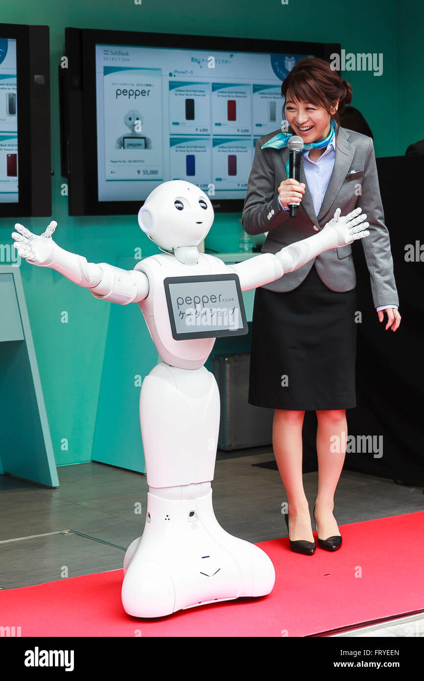 L to R) SoftBank robot Pepper and Japanese model Nana Suzuki speak during  the opening ceremony of a new phone store staffed entirely by robots in the  upmarket Omotesando shopping area on