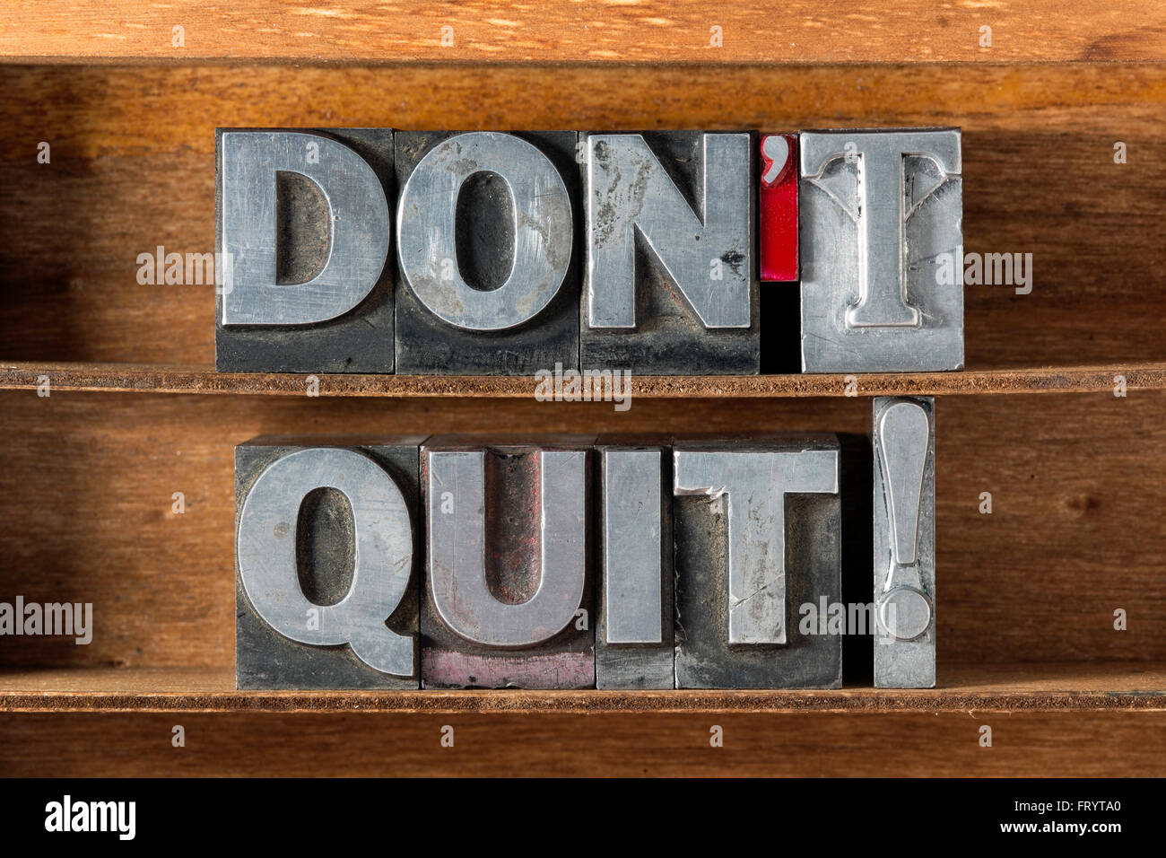 don’t quit exclamation made from metallic letterpress type on wooden tray Stock Photo