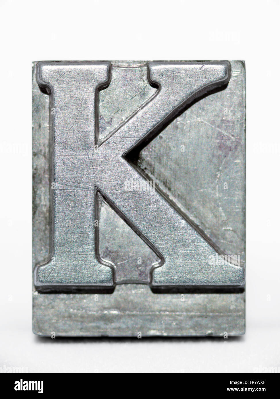 letter K metallic letterpress type block front view isolated on white Stock Photo