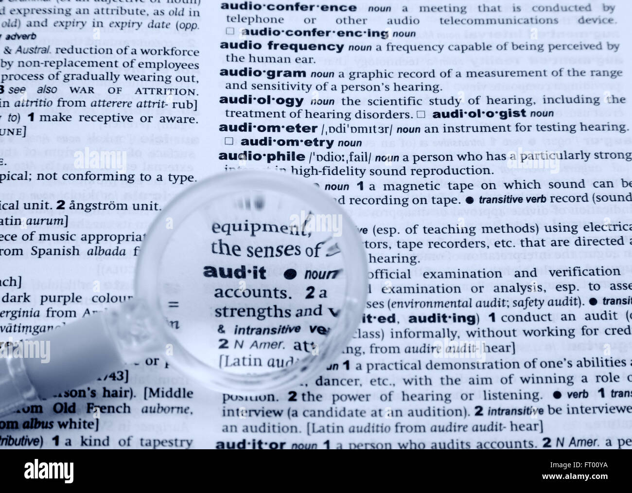 Dictionary and loupe. Black and White. Blue tone. Shallow DOF Stock