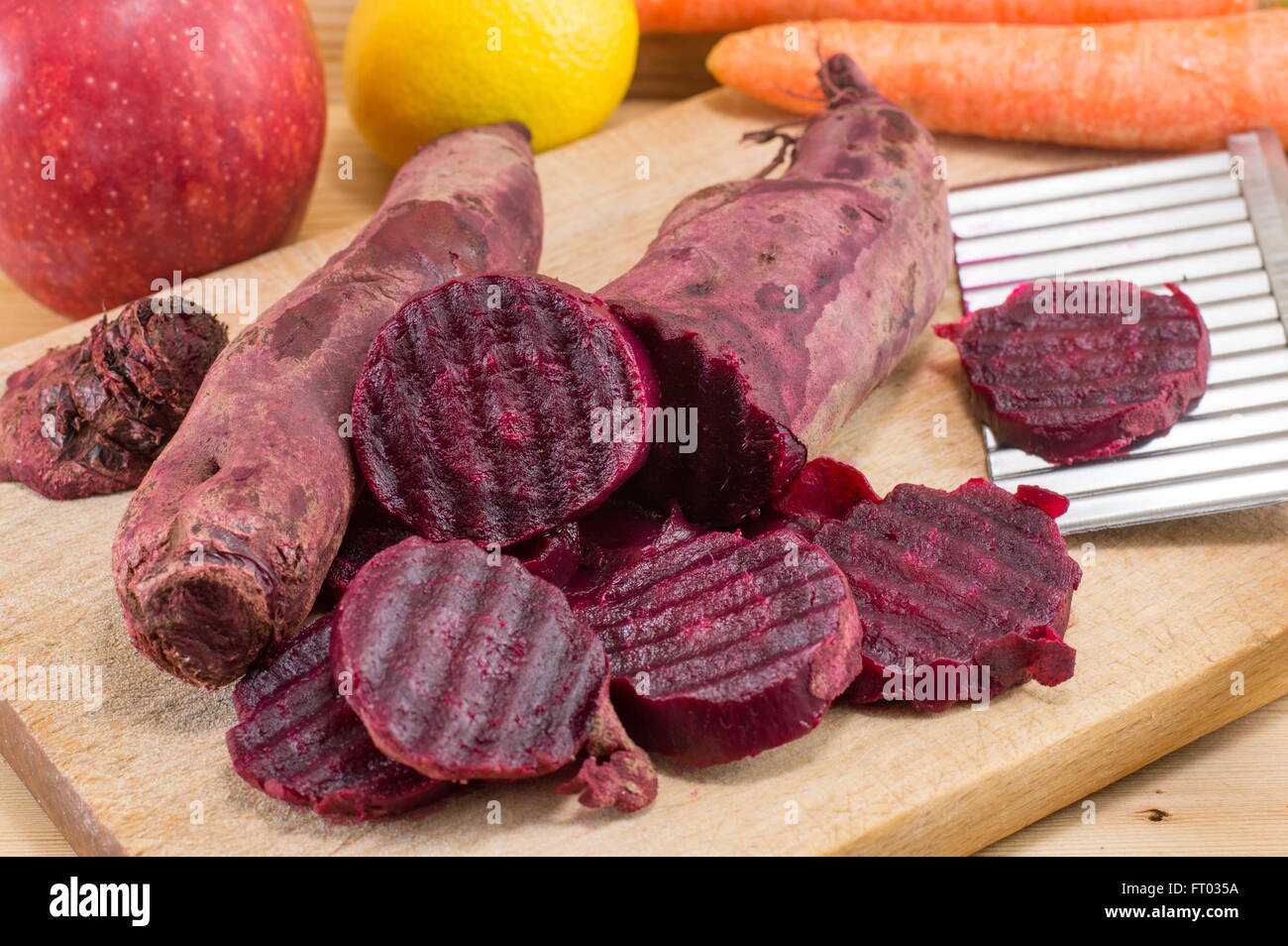 chopped beets and whole on a board Stock Photo