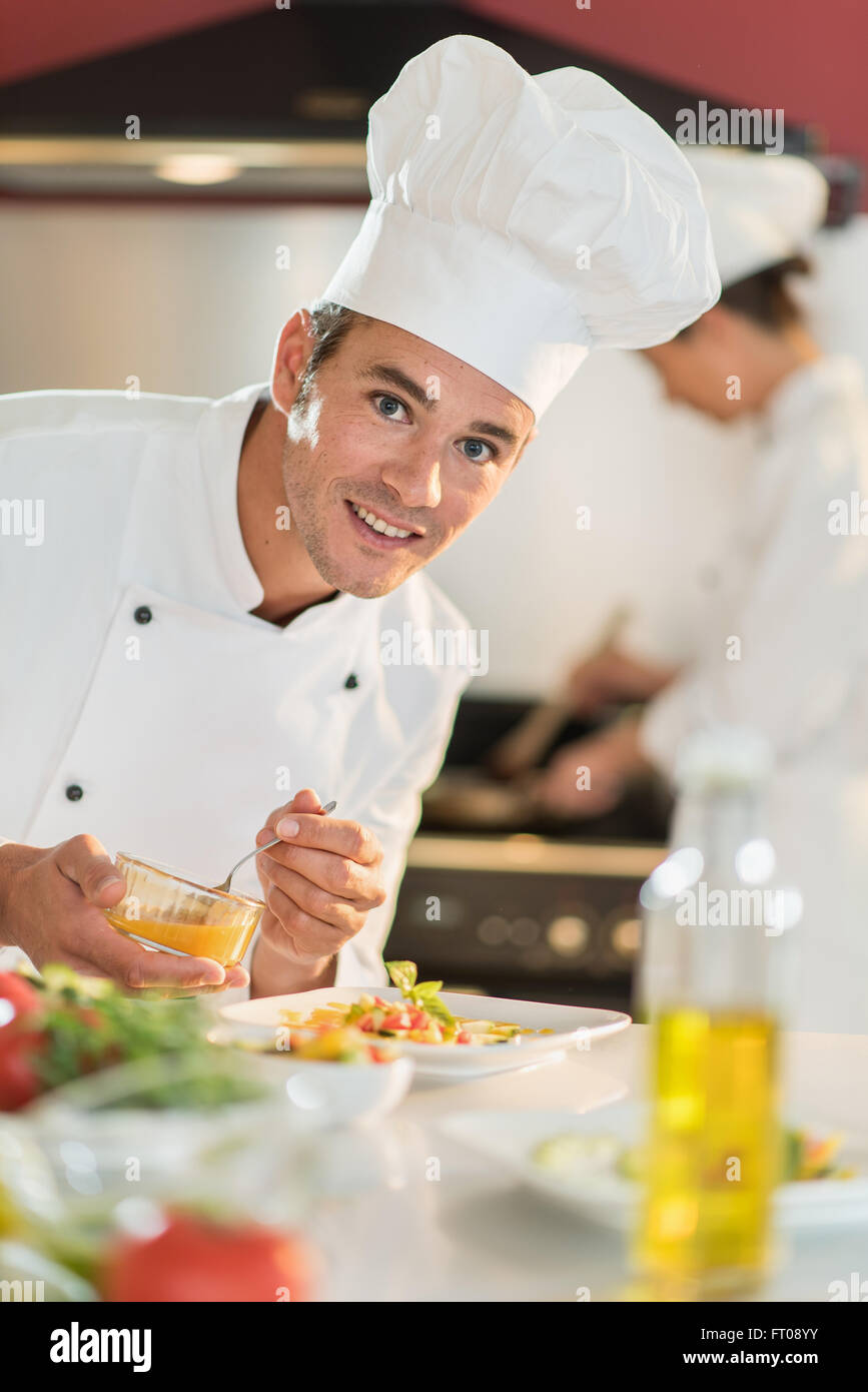 Portrait of a man cook chef in his forties. He is looking at camera and ...