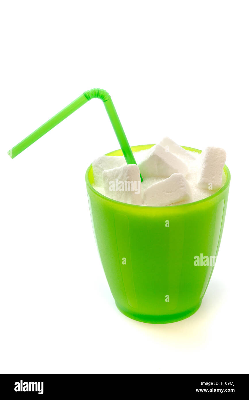 Green plastic glass with straw full of sugar and sugar cubes isolated on white background. Concept image for too much sugar in s Stock Photo