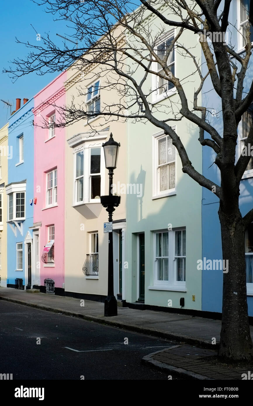 row of townhouses painted in pastel colours uk Stock Photo