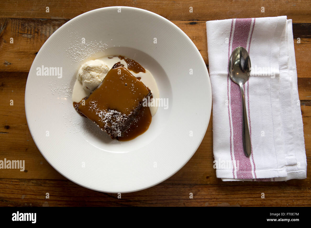Sticky toffee pudding served with vanilla ice cream in London, England
