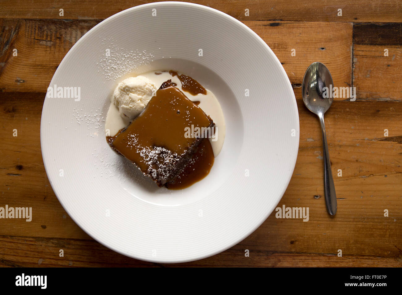 Sticky toffee pudding served with vanilla ice cream in London, England