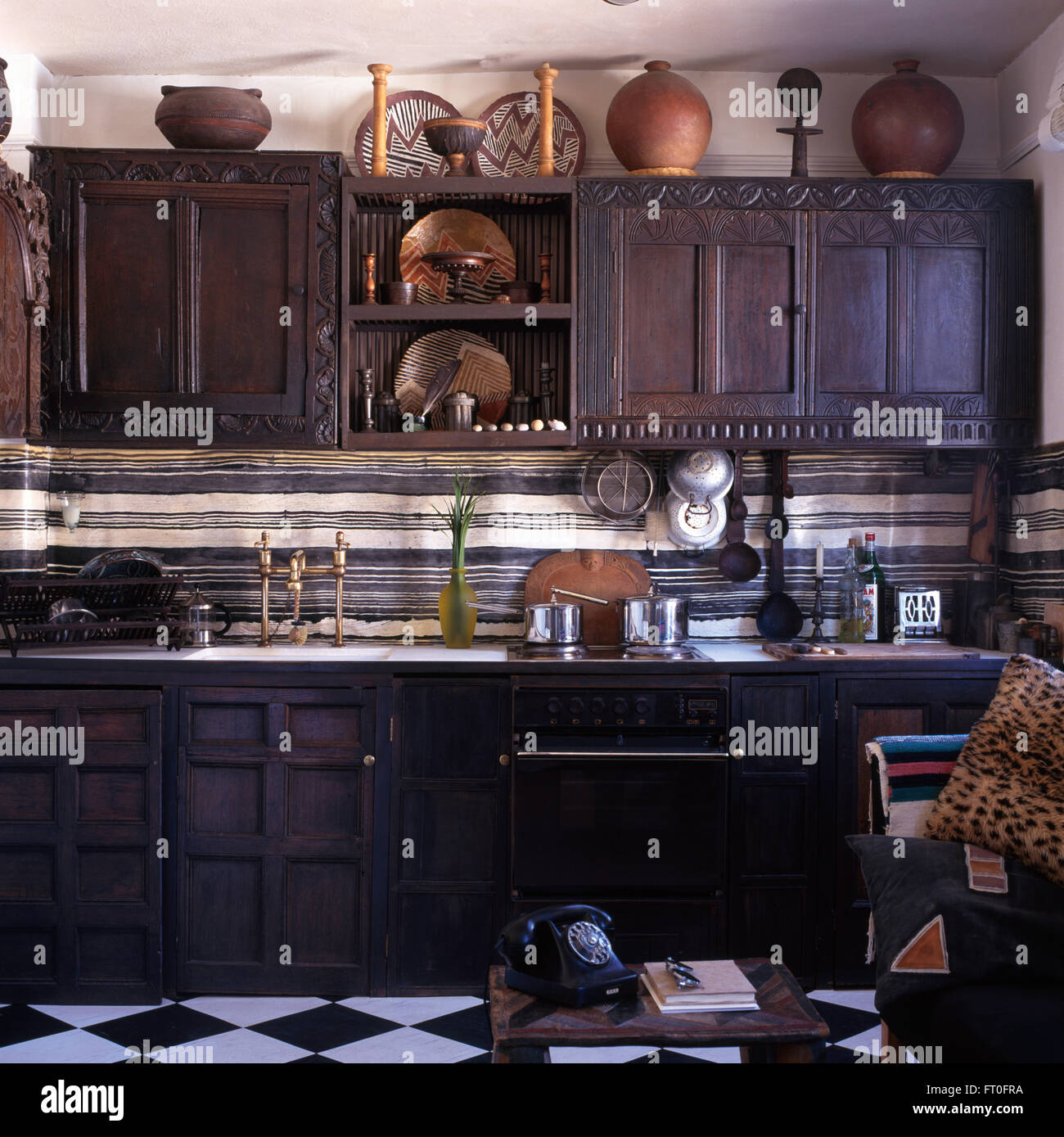 Dark oak doors on cupboards in kitchen with a vintage