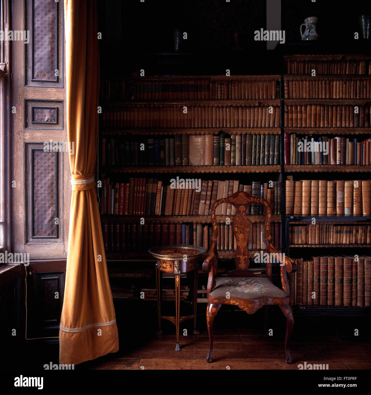 Antique Inlaid Chair In Front Of Bookcases With Antique Leather