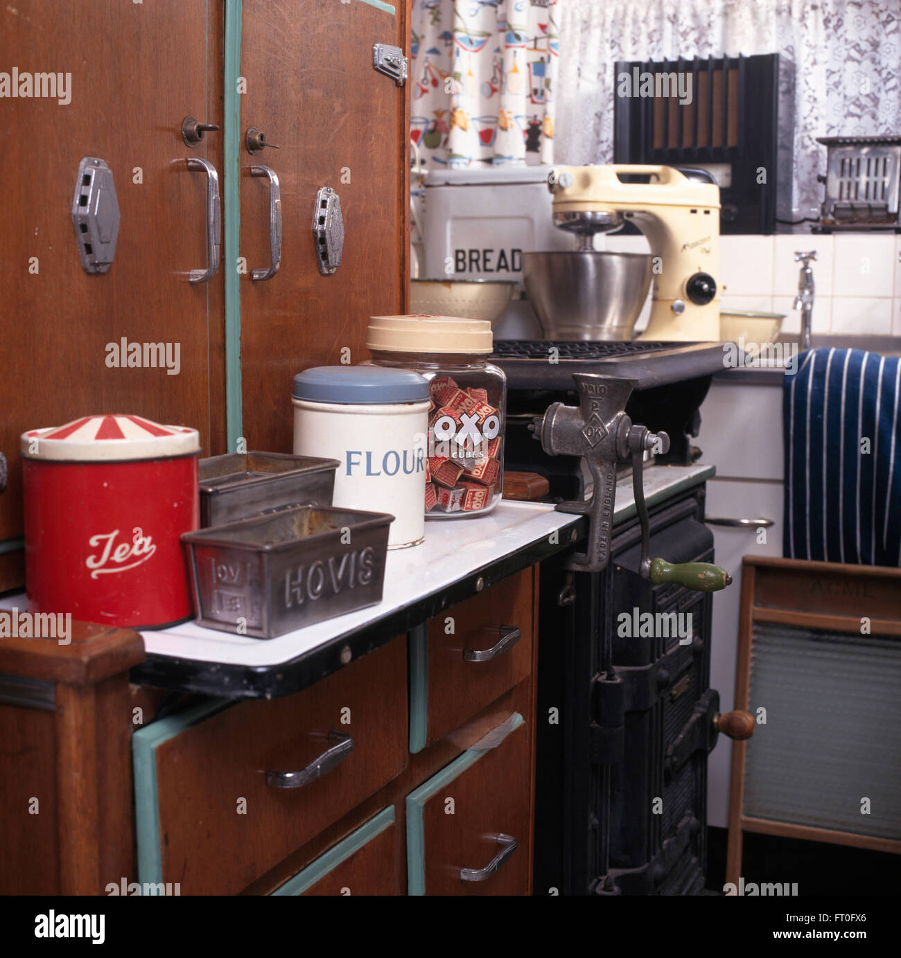Vintage storage tins and gas cooker in fifties kitchen Stock Photo