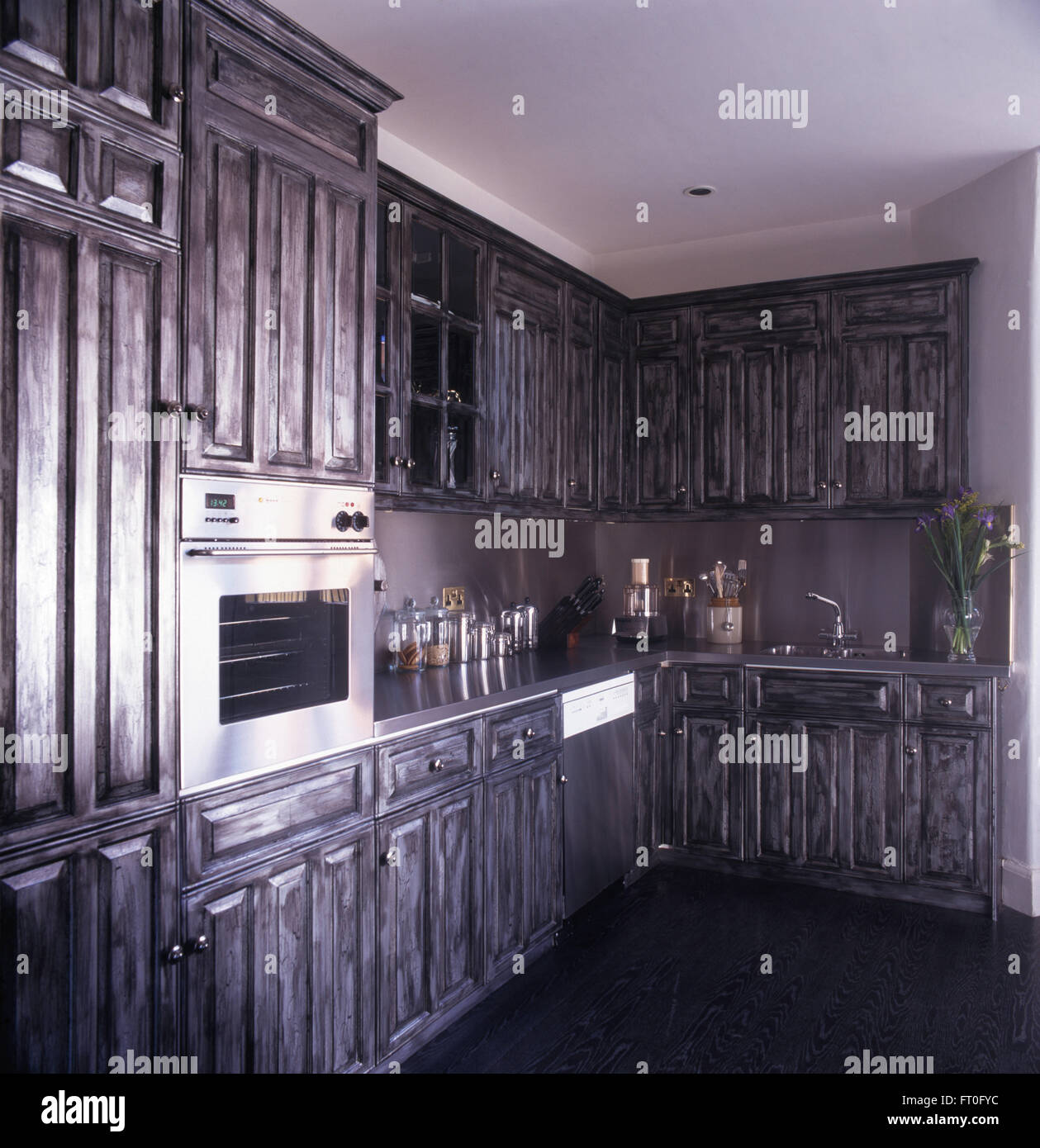 Silver gray painted fitted units in nineties kitchen Stock Photo
