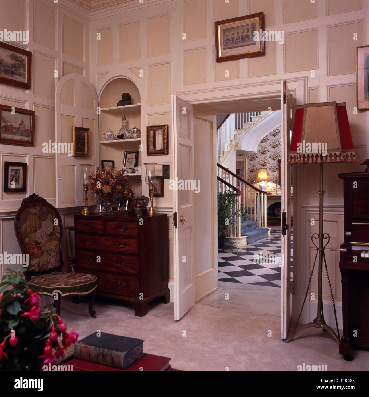 Antique tapestry chair and chestofdrawers below alcove cupboard in