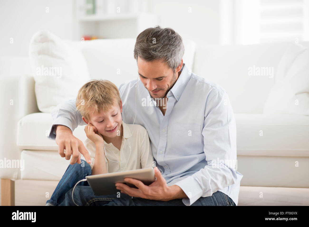 father and son sharing music headphones Stock Photo - Alamy