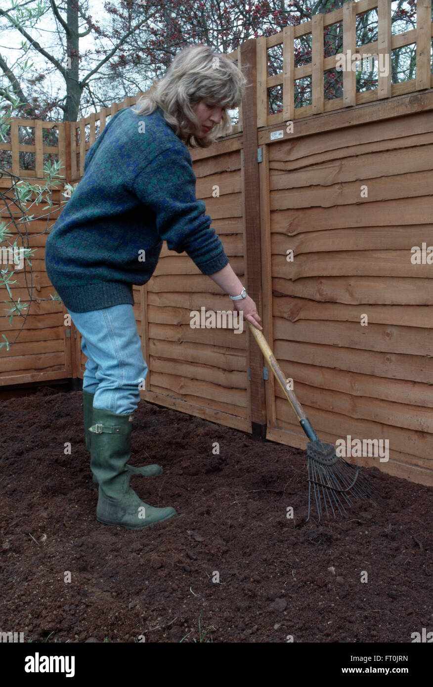 Woman raking a newly made border     FOR EDITORIAL USE ONLY Stock Photo