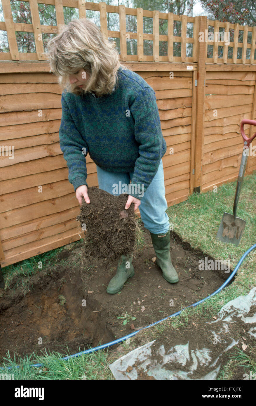 Woman removing turf from a lawn before making a new border     FOR EDITORIAL USE ONLY Stock Photo