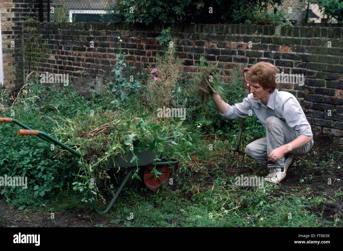 Gardener clearing an overgrown border     FOR EDITORIAL USE ONLY Stock Photo