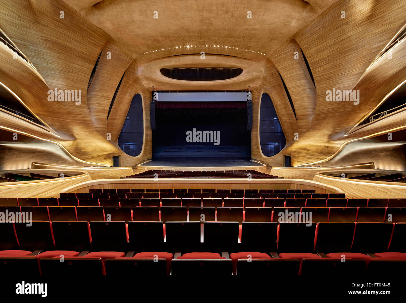 Multi-storey grand theatre interior with timber sculpted walls. Harbin ...